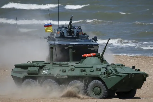 Russian (front) and Chinese armoured personnel carriers (APC) drive on a course of the Caspian Derby-2015 international naval contest during the International Army Games-2015 in the Dagestan's port city of Kaspiysk, Russia, August 5, 2015. (Photo by Sergei Karpukhin/Reuters)