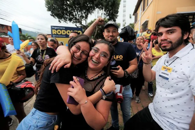 Supporters of Rodolfo Hernandez, presidential candidate with the Anti-corruption Governors League, celebrate as they listen to favorable partial results at his election night headquarters in Bucaramanga, Colombia, Sunday, May 29, 2022. (Photo by Mauricio Pinzon/AP Photo)