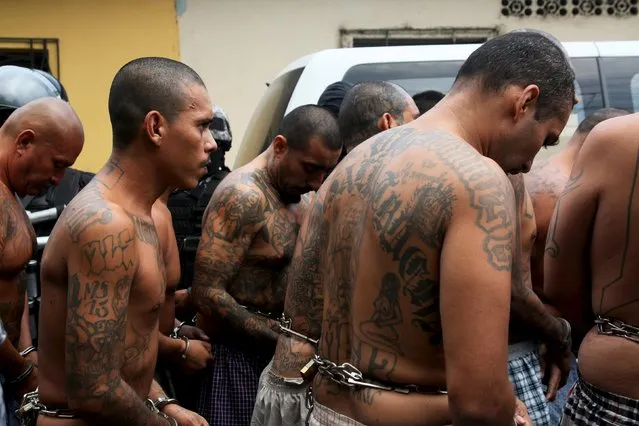 Members of the Mara Salvatrucha gang are guarded by policemen upon their arrival at the Quezaltepeque jail in Quezaltepeque, El Salvador, March 29, 2016. (Photo by Jose Cabezas/Reuters)
