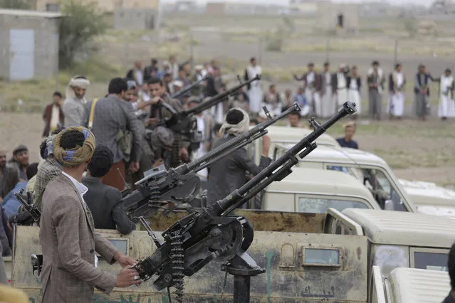 In this August 1, 2019, file photo, Houthi rebel fighters ride on trucks mounted with weapons, during a gathering aimed at mobilizing more fighters for the Houthi movement, in Sanaa, Yemen. Airstrikes by the Saudi-led coalition fighting Yemen’s rebels Houthi hit a detention center in southwestern province of Dhamar, officials and the rebels’ health ministry said Sunday. (Photo by Hani Mohammed/AP Photo/File)