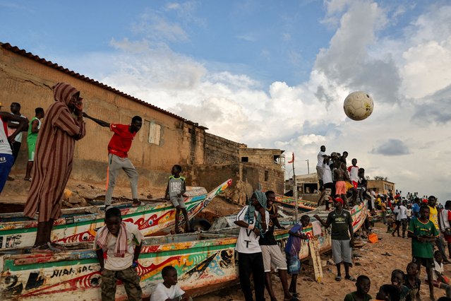 People watch a soccer game between two teams from the neighborhood in Toubab Dialaw on the outskirts of Dakar, Senegal on September 25, 2024. (Photo by Zohra Bensemra/Reuters)