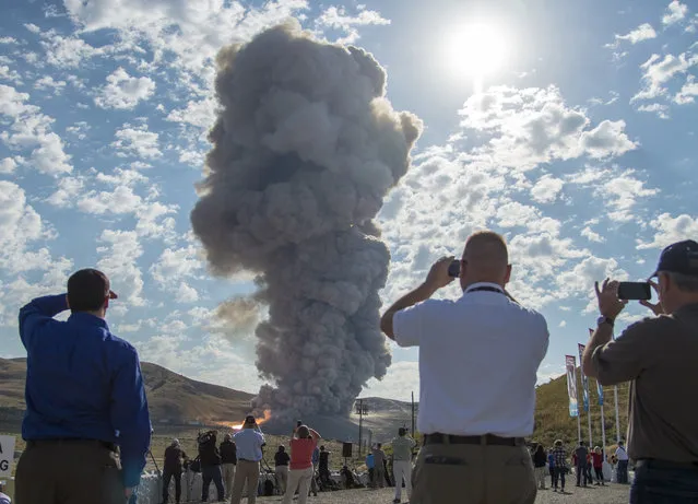 Spectators watch the second and final qualification motor (QM-2) test for the Space Launch System's booster, Tuesday, June 28, 2016, at Orbital ATK Propulsion Systems test facilities in Promontory, Utah. (Photo by Bill Ingalls/NASA via AP Photo)