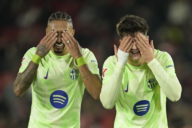 Barcelona's Pau Victor, right, celebrates with Raphinha after scoring his side's fifth goal during a Spanish La Liga soccer match between Mallorca and Barcelona at the Son Moix stadium in Palma de Mallorca, Spain, Tuesday, December 3, 2024. (Photo by Jose Breton/AP Photo)