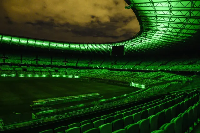 Mineirao Stadium is lit up in green, the color of hope, as a token of appreciation to all the professionals involved in the effort to minimize the spread of the coronoavirus pandemic (COVID-19) on April 2, 2020 in Belo Horizonte, Brazil. In addition to the lighting, the phrase “We are together and isolated” is projected on the stadium. (Photo by Pedro Vilela/Getty Images)