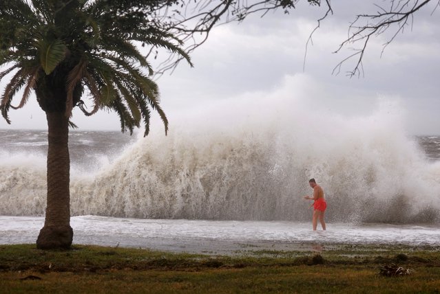Tanner Flynn stands in shallow water near crashing waves as Hurricane Helene passes offshore on September 26, 2024, in St. Petersburg, Florida. Helene is forecast to become a major hurricane, bringing the potential for deadly storm surges, flooding rain, and destructive hurricane-force winds along parts of the Florida West Coast. (Photo by Joe Raedle/Getty Images)