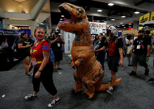 Fans of superhero movies, comic books and pop culture walk the convention floor in costume during the opening day of Comic-Con International in San Diego, California, United States July 21, 2016. (Photo by Mike Blake/Reuters)