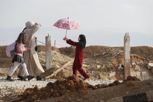 A family arrive to cross into Lebanon through the Jousieh border crossing, between Syria and Lebanon, November 28, 2024, following a ceasefire between Israel and Hezbollah that went into effect on Wednesday. (Photo by Omar Sanadiki/AP Photo)