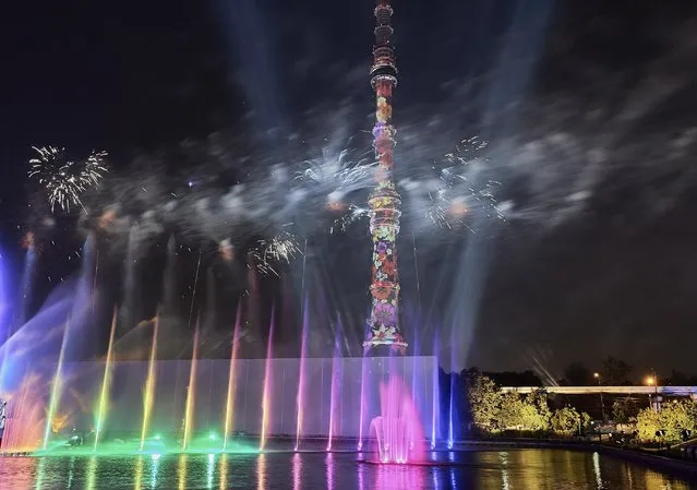 In this photo taken on Saturday, September 23, 2017, Fireworks explode over Moscow's Ostankino TV Tower and a pond during the VII Moscow International Festival Circle of Light in Moscow, Russia. (Photo by Dmitry Abaza/AP Photo)