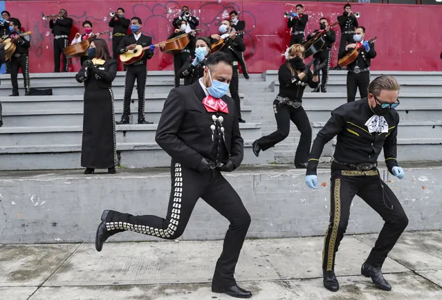Musicians from Mariachi groups perform during an event to ask authorities to allow them to work on the upcoming Mother's Day in Quito, Ecuador, Tuesday, May 5, 2020. The government ordered in mid-march a national lockdown to control the spread of the new coronavirus. (Photo by Dolores Ochoa/AP Photo)