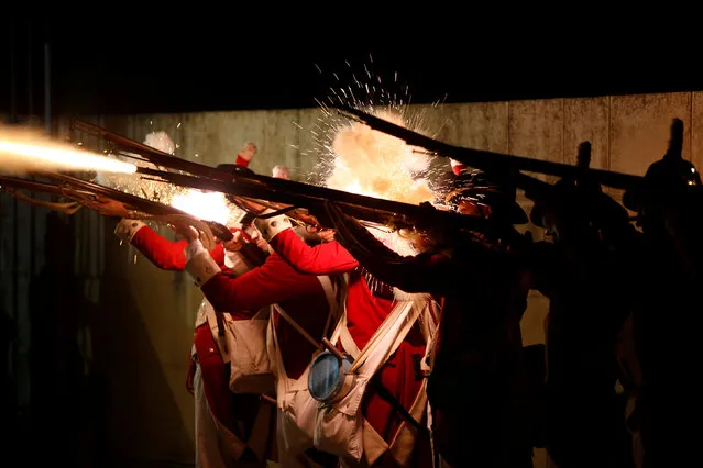 The British Marines unit of the Historical Reenactment Group Malta fire their muskets during “Birgu by Candlelight”, an annual event during which most street lights are switched off and the city is lit up by candlelight to create a magical ambience, in the medieval city of Birgu, also known as Vittoriosa, Malta, October 14, 2017. (Photo by Darrin Zammit Lupi/Reuters)