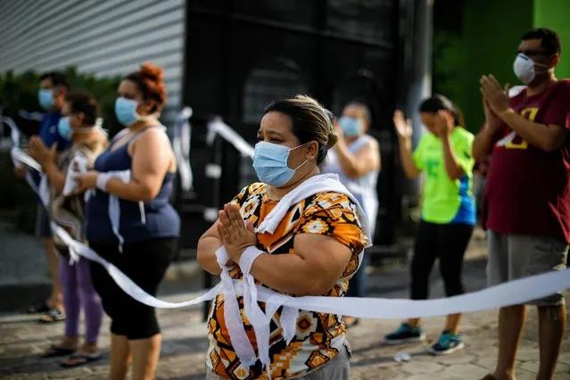 Catholics pray during a procession in honour of Our Lady of Fatima amid a nationwide quarantine as El Salvador's government undertakes steadily stricter measures to prevent the spread of the coronavirus disease (COVID-19), in San Salvador, El Salvador on May 12, 2020. (Photo by Jose Cabezas/Reuters)