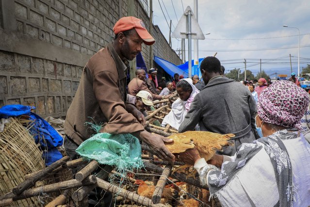 A man sells chickens in Sholla Market, the day before the Ethiopian New Year, in Addis Ababa, Ethiopia Saturday, September 10, 2022. (Photo by AP Photo/Stringer)