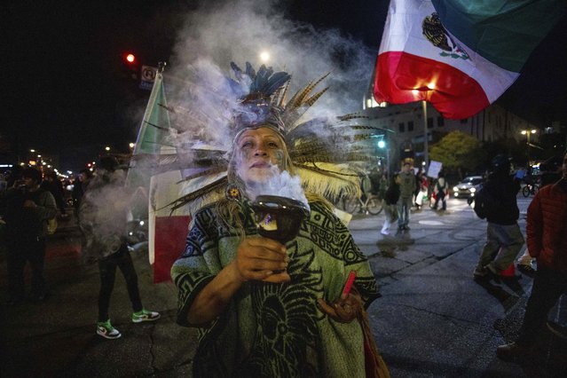 A women participates during an immigrant rights protest Monday, February 3, 2025, in Los Angeles. (Photo by Ethan Swope/AP Photo)
