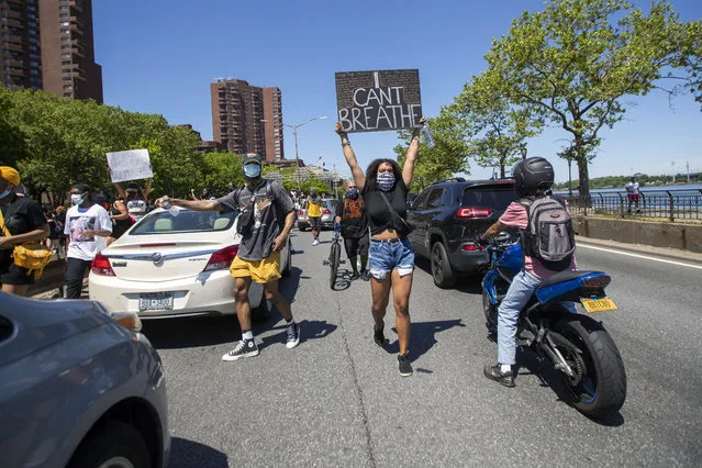 Protesters take to the FDR drive after marching through Harlem during a solidarity rally for George Floyd, Saturday, May 30, 2020, in New York. Floyd died after Minneapolis police officer Derek Chauvin pressed his knee into his neck for several minutes even after he stopped moving and pleading for air. (Photo byMary Altaffer/AP Photo)