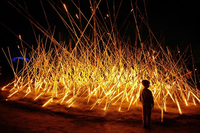 A child stands in front of a light sculpture at the Stavros Niarchos Foundation Cultural Center during Christmas festivities, in Athens, Greece on December 30, 2023. (Photo by Louiza Vradi/Reuters)