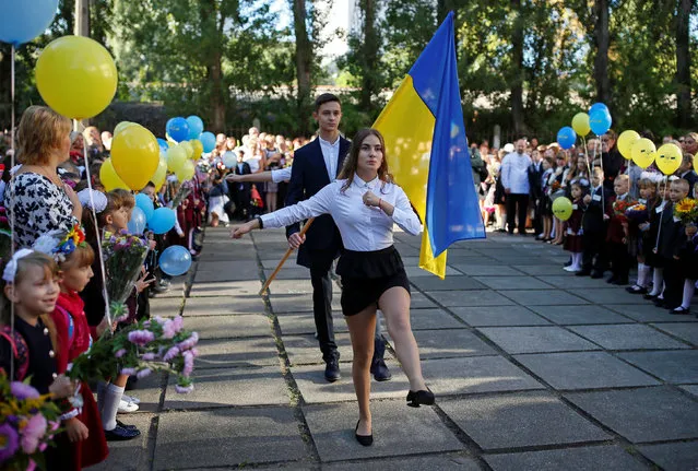 First graders attend a ceremony to mark the start of the school year in Kiev, Ukraine September 1, 2016. (Photo by Gleb Garanich/Reuters)