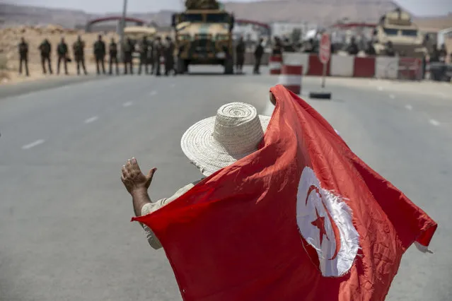 People stage a protest against the killing of a youth with a bullet in his own car at Tunisia's Libya border, asking for an investigation of the incident, on July 12, 2020 in Dehiba, Tunisia. (Photo by Yassine Gaidi/Anadolu Agency via Getty Images)
