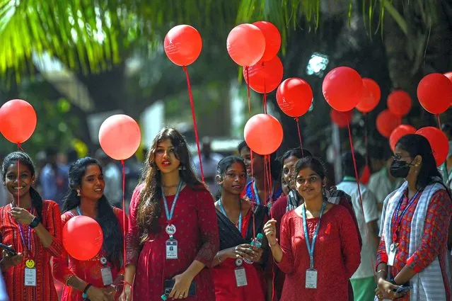 Students hold balloons as they take part in an awareness campaign on the occassion of 'World Aids Day' at Health and Family Welfare Training centre in Chennai on December 1, 2022. (Photo by Arun Sankar/AFP Photo)
