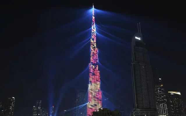 An LED light show illuminates the Burj Khalifa, the world's tallest building, to celebrate the New Year in Dubai, United Arab Emirates, Monday, January 1, 2018. (Photo by Jon Gambrell/AP Photo)