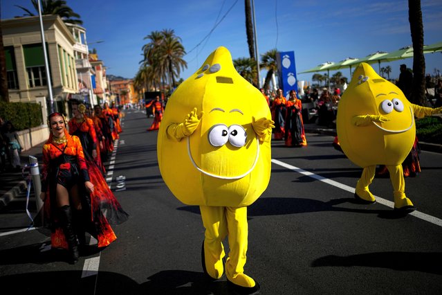 A carnival worker dressed as a lemon dances in the street during the 90th Olympia in Menton edition of the Lemon Festival in Menton, southern France, Saturday, February 17, 2024. (Photo by Daniel Cole/AP Photo)