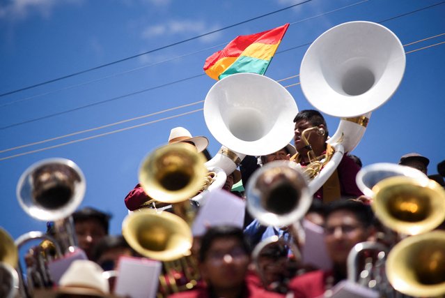 A Bolivian flag flies above the musicians who perform in the bands festival starting the Oruro Carnivall, in Oruro, Bolivia on February 3, 2024. (Photo by Claudia Morales/Reuters)