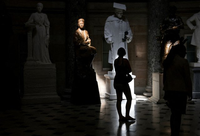 A statue of Rosa Parks is illuminated in the Statuary Hall, as visitors tour the U.S. Capitol building in Washington on June 23, 2025. (Photo by Evelyn Hockstein/Reuters)