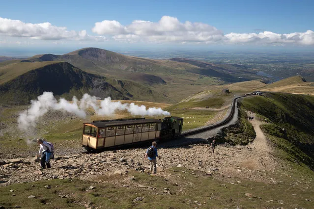 Snowdon Mountain Railway train and the Llanberis path, Snowdon, Snowdonia National Park, Gwynedd, Wales; United Kingdom, Europe. (Photo by Alamy Stock Photo)