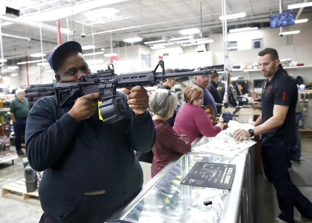 Ronnie Noble checks out a firearm on sale at the Rural King store in Gainesville, Fla.,  Friday November 24, 2017. (Photo by Brad McClenny/The Gainesville Sun via AP Photo)