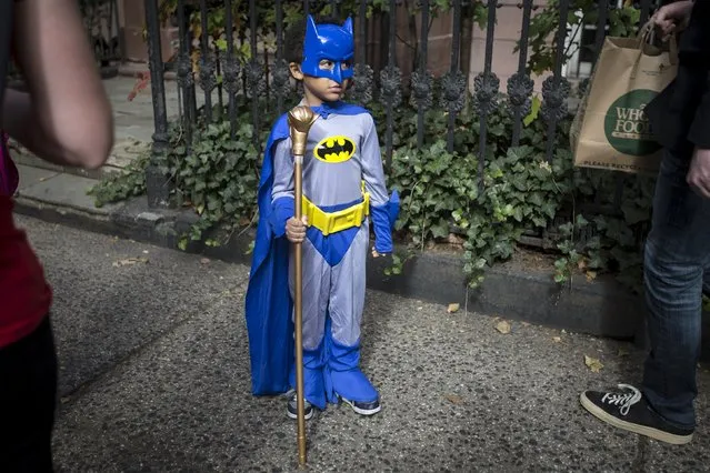 A child dressed as Batman takes part in the Children's Halloween day parade at Washington Square Park in the Manhattan borough of New York October 31, 2015. (Photo by Carlo Allegri/Reuters)
