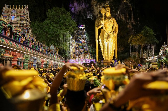 Hindu devotees carry pots of milk as they make their way to the Sri Subramaniar Swamy Temple during the Thaipusam celebrations at Batu Caves, Malaysia on February 11, 2025. (Photo by Hasnoor Hussain/Reuters)