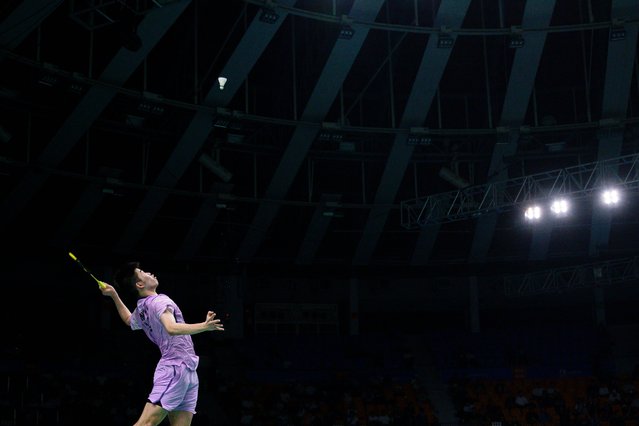 China's Weng Hongyang returns the shuttlecock to Indonesia's Alwi Farhan during their men's singles quarterfinal match at the Korea Open badminton tournament in Suwon on September 26, 2025. (Photo by Anthony Wallace/AFP Photo)