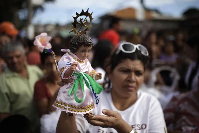 A Catholic faithful holds a figurine of baby Jesus during a religious procession on Holy Innocents Day in Antiguo Cuscatlan, on the outskirts of San Salvador, December 28, 2014. (Photo by Jose Cabezas/Reuters)