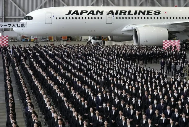 New employees of Japan Airlines Group (JAL) attend the company entrance ceremony at a Haneda airport maintenance hangar in Tokyo, Japan, 03 April 2023. Almost 2,000 new recruits from 37 JAL group companies attended the event at the start of the new fiscal year. The ceremony was held for the first time in four years following a suspension due to the Covid-19 pandemic. (Photo by Franck Robichon/EPA)