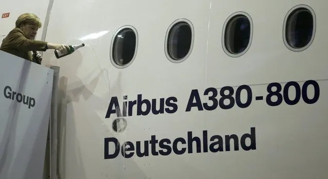 German Chancellor Angela Merkel christens an A380-800 aircraft named 'Deutschland' with Champagne, at the Lufthansa Technik facility in Frankfurt, Germany November 18, 2015. (Photo by Kai Pfaffenbach/Reuters)