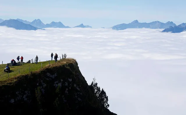 Tourists walk in the sun on the Niederhorn mountain near Interlaken, Switzerland October 5, 2016. (Photo by Ruben Sprich/Reuters)