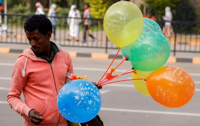A street vendor sells balloons during Eid al-Fitr celebration, marking the end of the fasting month of Ramadan, at the Meskel Square in Addis Ababa, Ethiopia on April 21, 2023. (Photo by Tiksa Negeri/Reuters)