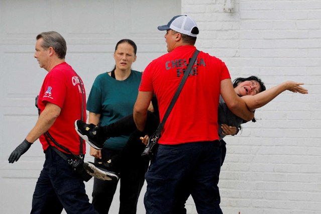 A woman is carried to an ambulance after witnesses say she was thrown to the ground while being detained by federal agents during an immigration raid in Chelsea, Massachusetts, on Friday, September 26, 2025. The agents released the woman at the scene after finding out she is a legal permanent resident, Reuters reported. (Photo by Brian Snyder/Reuters)