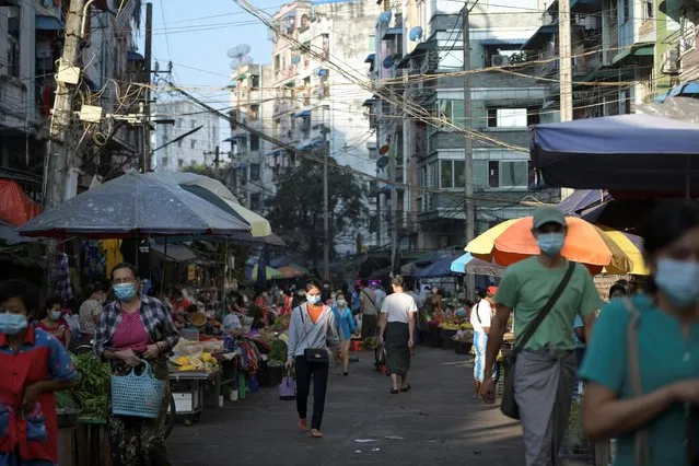 People walk at a market after army seized power in a coup in Yangon, Myanmar, February 2, 2021. (Photo by Reuters/Stringer)