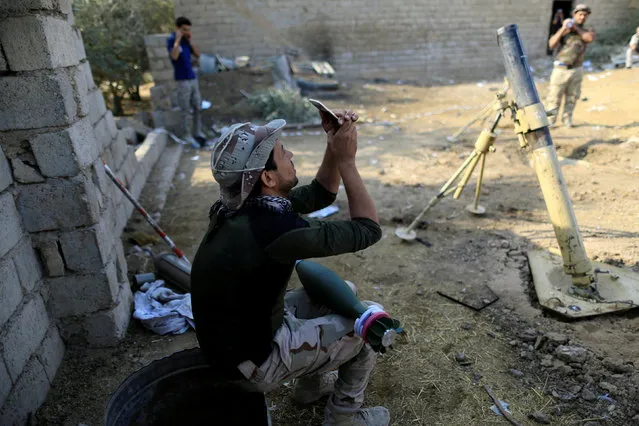 A soldier takes a selfie as rocket lies on his thigh during fighting with Islamic States militants, in the Shahrazad disrict of eastern Mosul, Iraq, November 6, 2016. (Photo by Zohra Bensemra/Reuters)