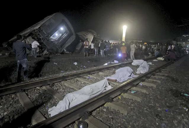 Bodies recovered from passenger trains lay on the track at the site of an accident, in Balasore district, in the eastern Indian state of Orissa, Saturday, June 3, 2023. Two passenger trains derailed in India, killing more than 200 people and trapping hundreds of others inside more than a dozen damaged rail cars, officials said. (Photo by AP Photo)