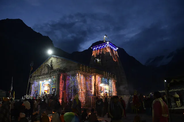 In this photograph taken on June 18, 2018, Indian Hindu devotees pay respects at the restored Kedarnath Temple that was hit during the deadly 2013 North India floods in Rudraprayag District in northern Uttarakhand state. Hindu devotees are visiting the restored Kedarnath Temple during the fifth anniversary of the devastating 2013 multi-day cloudburst which caused devastating floods and landslides, leaving more than 5,700 dead. (Photo by Shammi Mehra/AFP Photo)