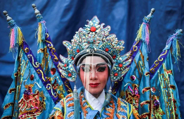 A traditional Chinese opera actress wearing a face shield poses for a picture during Lunar New Year celebrations in Bangkok, Thailand, February 12, 2021. (Photo by Chalinee Thirasupa/Reuters)