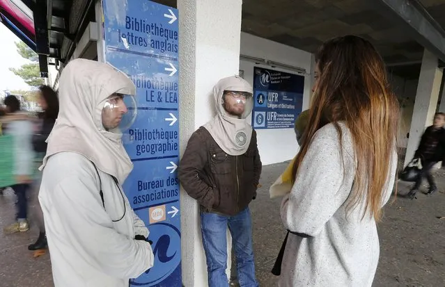 French twins Vincent and Thomas (L) Seris speak with a student at the university in Bordeaux, November 12, 2014. (Photo by Regis Duvignau/Reuters)