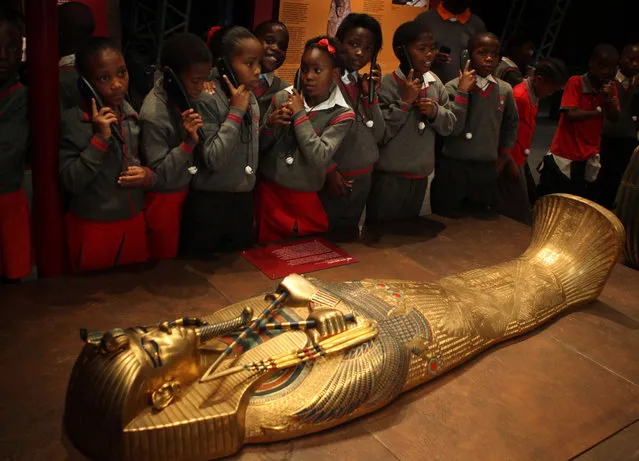 In this photo taken Wednesday, January 28, 2015, schoolchildren roam an exhibition of  replicas of Tutankhamun's treasures at an exhibition at a Krugersdorp, South Africa, Casino, brought to South Africa by Egypt's former top antiquities official Zahi Hawass. In an interview with the Associated Press, Hawass declared that “Egypt is safe” adding that antiquities sites are safe. (Photo by Denis Farrell/AP Photo)