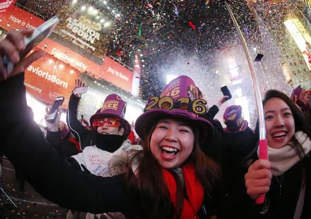 Revelers ring in the new year at Times Square, Friday, January 1, 2016, in New York. (Photo by Julio Cortez/AP Photo)