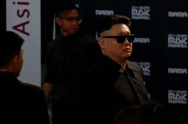 An unidentified man dressed as North Korean leader Kim Jong-un tries to enter the red carpet of Mnet Asian Music Awards (MAMA) before being away, in Hong Kong, China December 2, 2016. (Photo by Bobby Yip/Reuters)