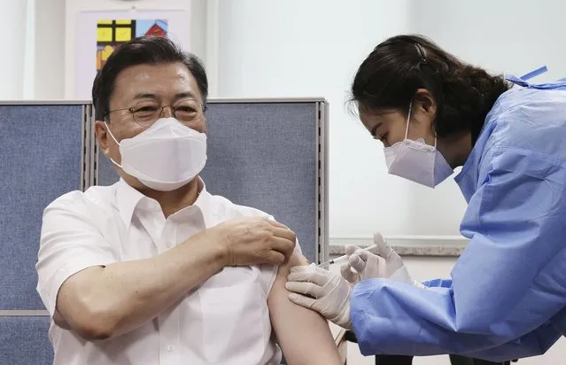South Korean President Moon Jae-in, left, receives his second dose of the AstraZeneca COVID-19 vaccine at a health care center in Seoul, South Korea, Friday, April 30, 2021. (Photo by Lee Jin-wook/Yonhap via AP Photo)
