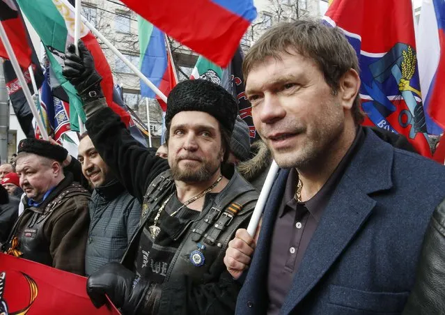 Pro-Russian politician Oleg Tsarev (R) and leader of the motorcycling club Night Wolves Alexander Zaldostanov (C) attend an "Anti-Maidan" rally to protest against the 2014 Kiev uprising, which ousted President Viktor Yanukovich, in Moscow February 21, 2015. Thousands of Russians marched in Moscow on Saturday, carrying banners and signs disavowing the protests at Kiev's Independence Square, or Maidan, last year that ousted a Russian-backed president and created a rift between Ukraine and the West and Russia. REUTERS/Sergei Karpukhin (RUSSIA - Tags: POLITICS CIVIL UNREST)