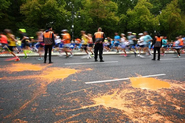 General view during the Berlin Marathon as orange paint is seen in the road from a “Letzte Generation” demonstration in Berlin, Germany on September 24, 2023. (Photo by Annegret Hilse/Reuters)