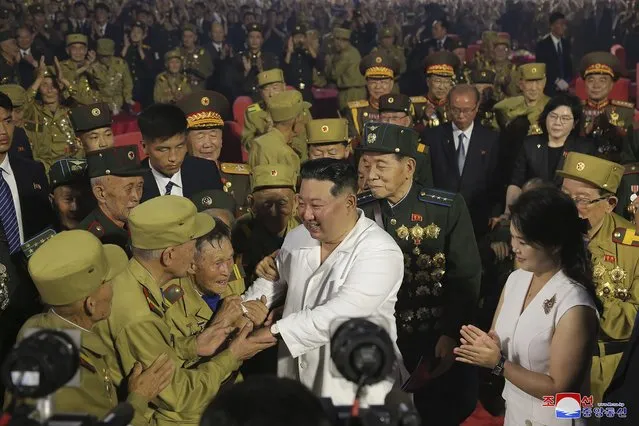 In this photo provided by the North Korean government, North Korean leader Kim Jong Un, center front, shakes hands with war veterans during a ceremony to mark the 69th anniversary of the signing of the ceasefire armistice that ends the fighting in the Korean War, in Pyongyang, North Korea Wednesday, July 27, 2022. Independent journalists were not given access to cover the event depicted in this image distributed by the North Korean government. The content of this image is as provided and cannot be independently verified. Korean language watermark on image as provided by source reads: “KCNA” which is the abbreviation for Korean Central News Agency. (Photo by Korean Central News Agency/Korea News Service via AP Photo)